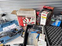 Overall lot showing Iron Force box, SKIL box, saw case, foam case
