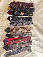 Full group of 11 neckties laid flat showing overall variety