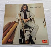 Front album jacket showing Eric Clapton seated with guitar
