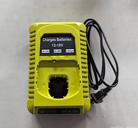 Front view of yellow 12-18V Ryobi battery charger with indicator panel and cord