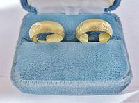 Hoop earrings in presentation case, front view showing texture and chevron detail