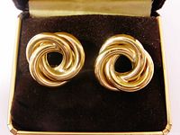 Front view of both gold love knot earrings in box