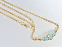 Necklace laid out showing chain, clasp, and gemstone bar