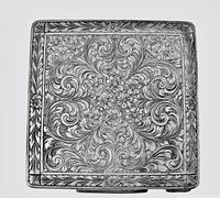 Top view of square compact showing full floral scroll engraving detail
