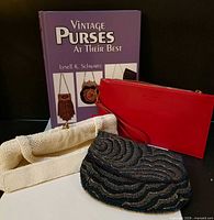 Front view of book and three purses