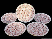 Five Rougemont plates displayed, pattern and trim visible