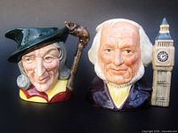 Front view of John Doulton and Pied Piper jugs side by side