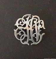 front view of sterling silver monogram brooch