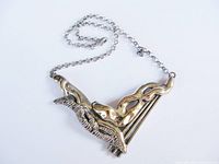 Full view of silver and gilt abstract necklace with chain and lobster clasp