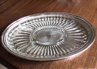 Two-piece relish tray assembled showing pressed-glass liner seated in silver-plate tray