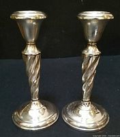 Two matching sterling candlesticks front view