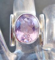 Front view of sterling silver ring with light amethyst centre stone
