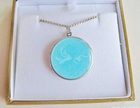 Locket necklace displayed in open presentation box showing enamel face