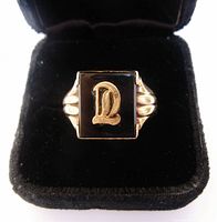 Front view showing onyx face with gold initial and overall design