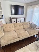 Full view of beige 3-seater sofa in room