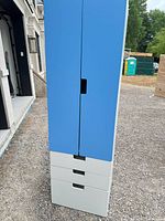 Full view tall blue-white cabinet with three lower drawers