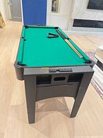 table set up for billiards with cues and rack
