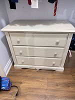 Front view of dresser showing three drawers and overall style
