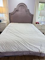 Full view of bed showing headboard, mattress, and box spring