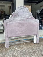 Full view of queen pink velvet headboard wrapped for transport
