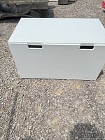 front view showing recessed handles and hinged lid