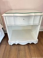 front view of nightstand showing drawer, shelf, glass top