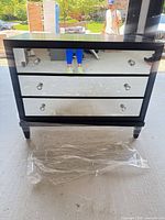 Front view showing mirrored drawers and knobs