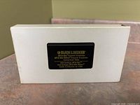 VHS tape partially exposed in white sleeve displaying Black & Decker branding
