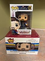 Front view of boxed Doctor Strange Pop! #169 figure on top of boxed Doctor Strange Pop! Home mug