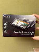 Front of Garmin DriveLuxe 50 retail box showing model, screen size and features icons