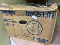 Outer box showing Kimberly-Clark branding and handwritten notes
