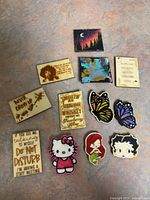 Group shot showing all 12 items: plaques, magnets, canvases