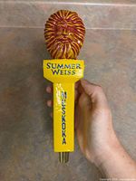 Full view of tap handle front showing lion head, lettering, metal ferrule