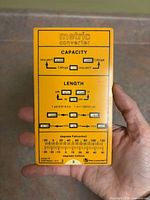 Front of yellow metric converter card showing capacity and length scales