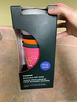 Retail package showing stacked multi-color Starbucks reusable hot cups and label details