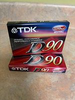 Front view showing two sealed TDK D90 cassette tapes