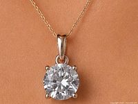 Pendant on neckline showing diamond size and chain