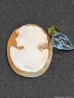 Shell cameo cabochon, blue pear-cut stone, green pear-cut stone