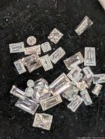 Close-up view of assorted loose diamonds on black background