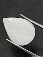 Front view of pear-shaped opal showing play-of-colour