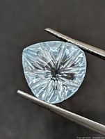 Front view of blue topaz showing starburst faceting