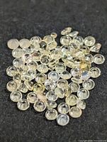 Loose round faceted gemstones on black background