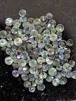 Loose round faceted gemstones grouped together