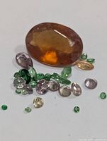 Group of loose faceted gemstones showing size and colour variety