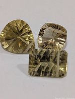 Three faceted lemon quartz gemstones front view