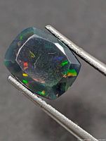 Front view of faceted opal showing play of colour