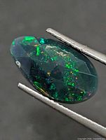Front view of oval faceted opal showing play-of-color