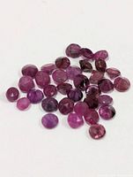Loose rubies spread out for size and colour reference