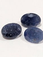 Three loose oval blue sapphires close-up