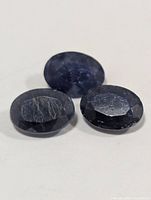 Three oval sapphires close-up showing color and inclusions